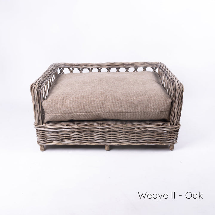 Luxury wicker dog bed - Charley Chau's Raised Rattan Dog Bed - with a deep-filled dog bed mattress in a warm oak colour, placed on a white background.