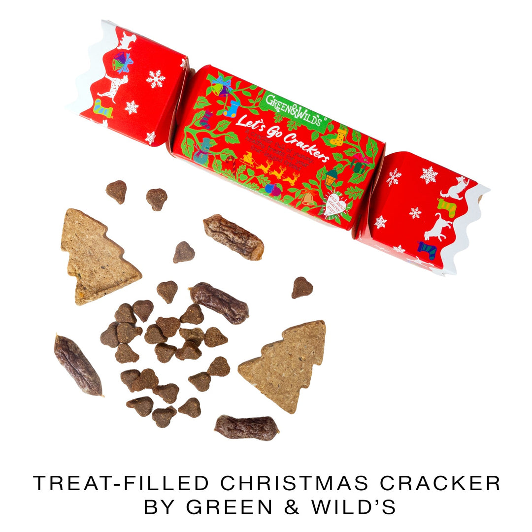 Treat-filled Christmas cracker by Green & Wild's with red and green packaging and various dog treats.