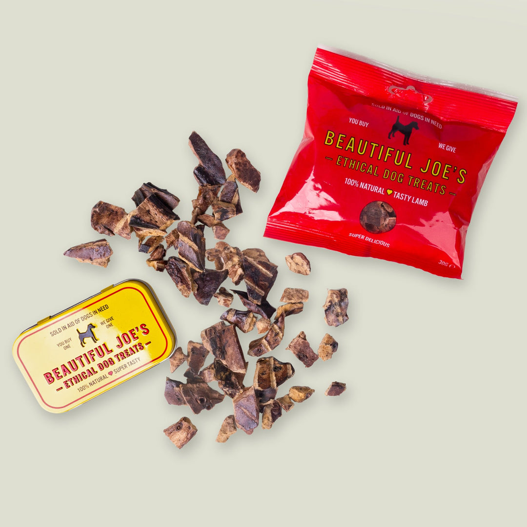 A red packet of 100% natural lam liver dog treats and a yellow storage tin for the treats.