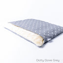 Luxury dog bed with cover, a Charley Chau Dog Burrow Bag, in a grey polka dot print fabric with a cream faux-fur lining.