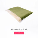 Luxury Dog Burrow Bag, a sleeping bag style or snuggle sack style dog bed, with a moss green Velour outer cover and a plush cream faux-fur lining on a white backdrop.