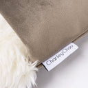 Close up shot of the a luxury dog burrow bag in brown velour with cream faux-fur and a Chalrey chau brand label.