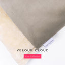 Close up of the corner of a luxury Dog Burrow Bag, a snuggle sack style dog bed or sleeping bag style dog bed, with a light grey upholstery-quality Velour outer cover and plush cream faux-fur lining, showing a Charley Chau designer brand label on the dog bed, on a white background.