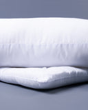 Two white dog bed mattresses - one mattress is thick, once mattress is slimline, on a gray background.