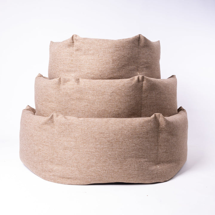 A stack of luxury donut dog beds by designer Charley Chau in three sizes to suit all breeds of dogs. The Ducky Donut Dog Bed is made to perform over time.