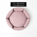 Pale Pink luxury donut dog bed on a white background with 'ITV - Britain's Top 100 Dogs' media feature badge