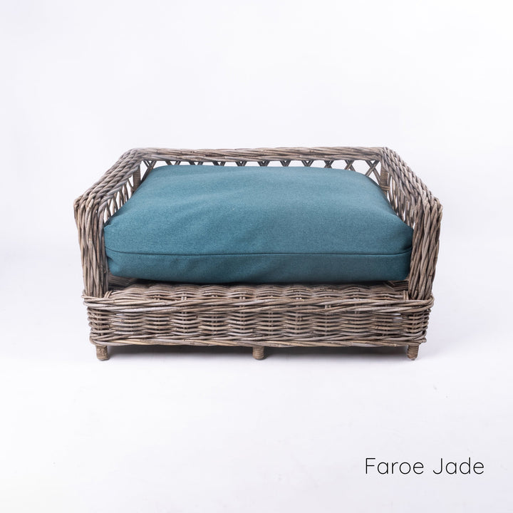 Luxury wicker dog bed - Charley Chau's Raised Rattan Dog Bed - with a deep-filled dog bed mattress in a vibrant jade colour, placed on a white background.