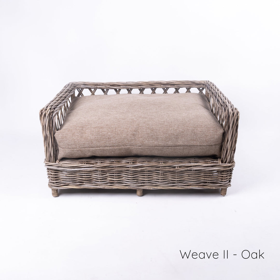 Luxury wicker dog bed - Charley Chau's Raised Rattan Dog Bed - with a deep-filled dog bed mattress in a warm oak colour, placed on a white background.