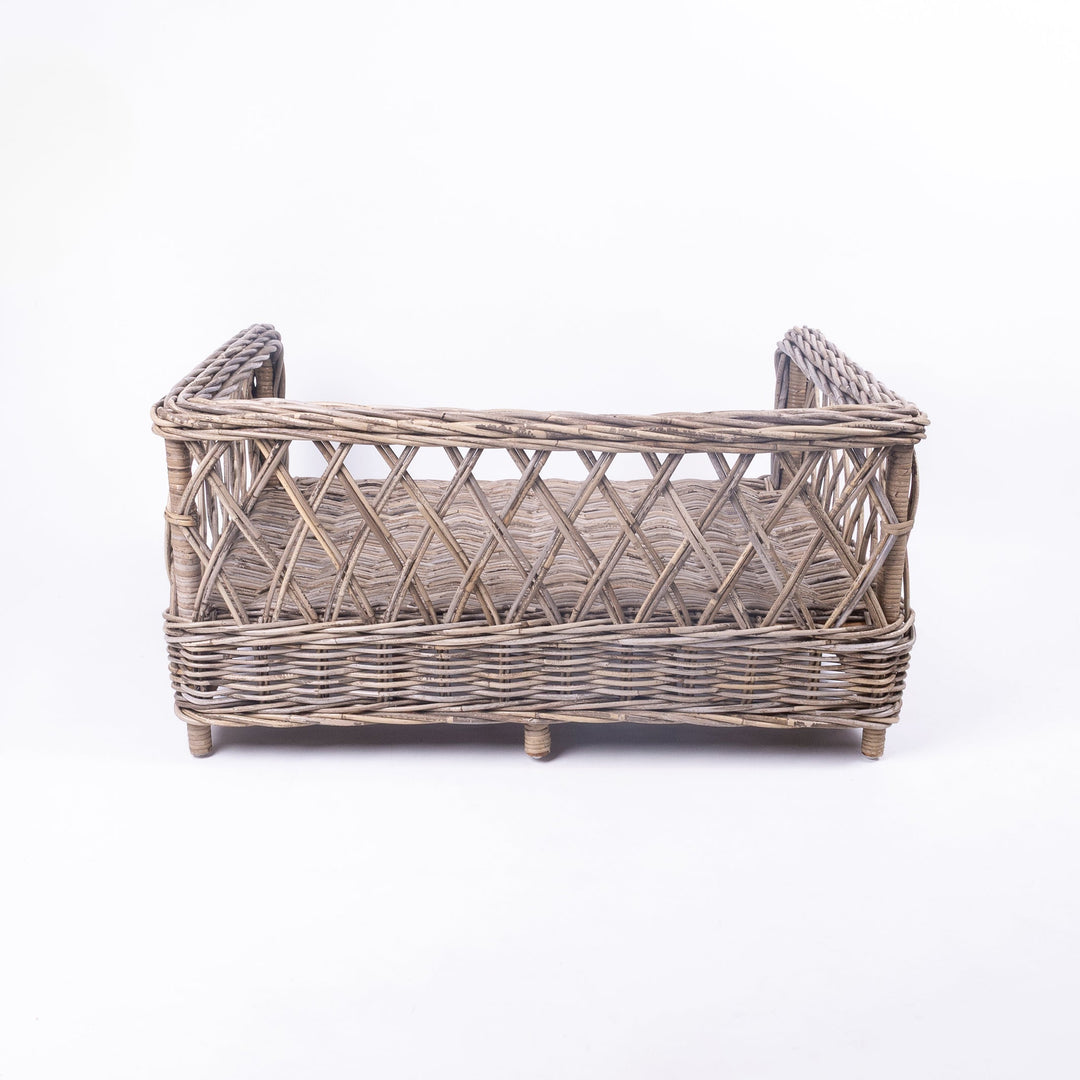 Rear view of Charley Chau's Raised Rattan Dog Bed frame, woven with natural rattan canes with a lattice effect, placed on a white background.