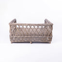 Rear view of Charley Chau's Raised Rattan Dog Bed frame, woven with natural rattan canes with a lattice effect, placed on a white background.