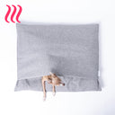 Italian Greyhound dog peeking out of a luxury sleeping bag style dog burrow bag by Charley Chau in a grey woven upholstery fabric with the Charley Chau brand label visible, on a white background.