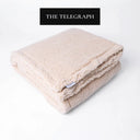 Folded beige Sherpa Fleece Dog Blanket on a white background with a media feature badge for 'The Telegraph' above.