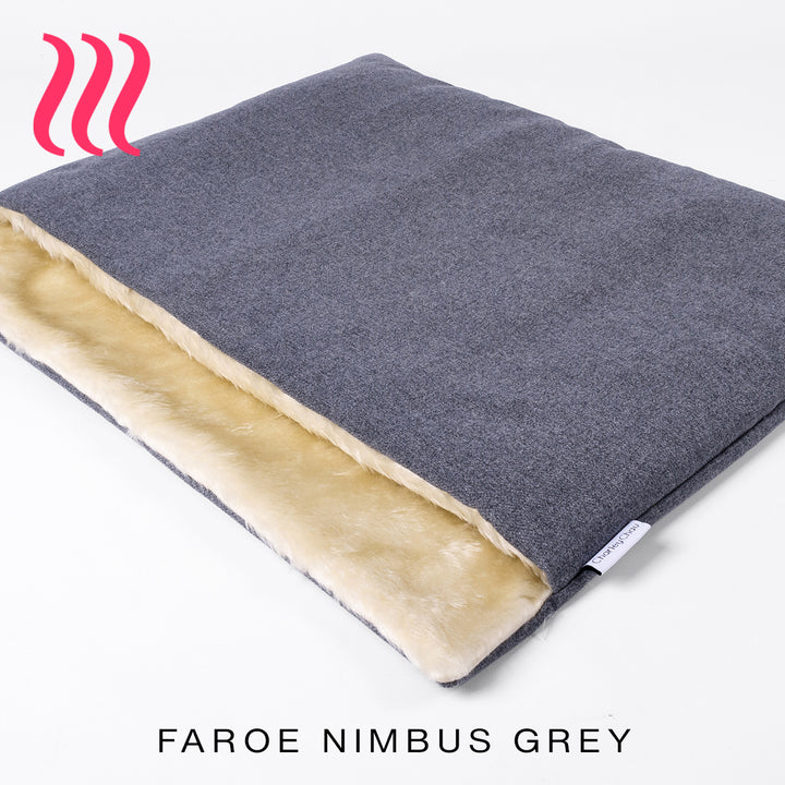 Luxury sleeping bag stlye dog bed outer cover in mid grey upholstery fabric with a cream faux-fur lining on a white background.