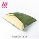 Luxury Dog Snuggle Bed, a sleeping bag style dog bed, with the outer cover in a leaf green colour velvet and cream faux-fur on the inside of the bed, on a white background.