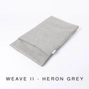 Folded Spare Bed Cover for a Charley Chau luxury dog snuggle Bed and dog burrow bag in a grey, textured upholstery fabric that is scrabble resistant and scratch resistant, with text "Weave II - Heron Grey".