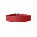 A handcrafted, bespoke red leather dog collar in a classic cut, made to order to fit all breeds and sizes of dog, from the finest Italian Calf Leather, on a white background.