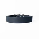 A close-up of a bespoke dark blue  leather dog collar with visible stitching, made with fine Italian Calf leather, labelled 'MADEIRA BLUE' below on a white background.