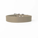 A handcrafted, bespoke pale beige leather dog collar in a classic cut, made to order to fit all breeds and sizes of dog, on a white background.
