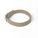 A handcrafted, bespoke pale beige leather dog collar in a classic cut, made to order to fit all breeds and sizes of dog, on a white background.