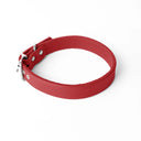 A handcrafted, bespoke red leather dog collar in a classic cut, made to order to fit all breeds and sizes of dog, on a white background.