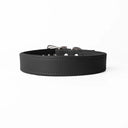 A handcrafted, bespoke black leather dog collar in a classic cut, made to order with finest quality Italian Calf Leather, to fit all breeds and sizes of dog, on a white background.