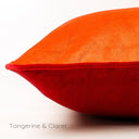 Closeup of a two-toned machine washable velvet dog bed in vibrant red and orange a white background, Tangerine & Claret.