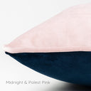 Closeup of a two-toned machine washable velvet dog bed in pink and navy on a white background, Midnight & Palest Pink.