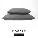 Two luxury dog bed mattresses in a dark charcoal grey upholstery fabric stacked on top of each other, with 'BASALT' and a black 'Styled To Order' label on a white background; these machine washable dog bed mattresses are made for lasting comfort and easy care.