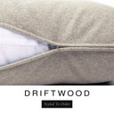 Close-up of a warm sandy taupe machine washable dog bed mattress with its removable cover partially unzipped, revealing the deep-filled luxury dog bed mattress inside, above a white banner with the text 'DRIFTWOOD' and 'Styled To Order'.