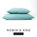 Two luxury dog bed mattresses in a soft powder blue upholstery fabric stacked on top of each other, with 'ROBIN'S EGG' and a black 'Styled To Order' label on a white background; these machine washable dog bed mattresses are made for lasting comfort and easy care.