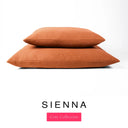 Two luxury machine washable dog bed mattresses in a burnt orange upholstery fabric stacked on top of each other with 'SIENNA' and a pink 'Core Collection' label on a white background. 