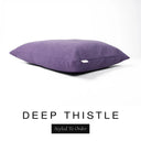 A luxury dog bed mattress in a rich deep purple upholstery fabric with 'DEEP THISTLE' and a black 'Styled To Order' label on a white background; this machine washable dog bed mattress is designed for everyday comfort.