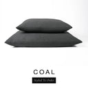 Two luxury dog bed mattresses in a dark charcoal black upholstery fabric stacked on top of each other, with 'COAL' and a black 'Styled To Order' label on a white background; these machine washable dog bed mattresses are made for lasting comfort and easy care.