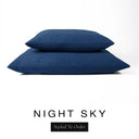 Two luxury dog bed mattresses in a deep navy blue upholstery fabric stacked on top of each other, with 'NIGHT SKY' and a black 'Styled To Order' label on a white background; these machine washable dog bed mattresses are made for lasting comfort and easy care.