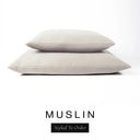 Two luxury dog bed mattresses in a soft warm cream upholstery fabric stacked on top of each other, with 'MUSLIN' and a black 'Styled To Order' label on a white background; these machine washable dog bed mattresses are made for lasting comfort and easy care.