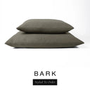 Two luxury dog bed mattresses in a deep olive brown upholstery fabric stacked on top of each other, with 'BARK' and a black 'Styled To Order' label on a white background; these machine washable dog bed mattresses are made for lasting comfort and easy care.