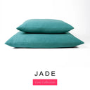 Two luxury dog bed mattresses in a deep teal green upholstery fabric stacked on top of each other, with 'JADE' and a pink 'Core Collection' label on a white background; these machine washable dog bed mattresses are made for lasting comfort and easy care.