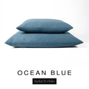 Two luxury dog bed mattresses in a deep petrol blue upholstery fabric stacked on top of each other, with 'OCEAN BLUE' and a black 'Styled To Order' label on a white background; these machine washable dog bed mattresses are made for lasting comfort and easy care.