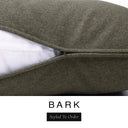 Close-up of a deep olive brown machine washable dog bed mattress with its removable cover partially unzipped, revealing the deep-filled luxury dog bed mattress inside, above a white banner with the text 'BARK' and 'Styled To Order'.