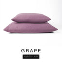 Two luxury dog bed mattresses in a dusky mauve-purple upholstery fabric stacked on top of each other, with 'GRAPE' and a black 'Styled To Order' label on a white background; these machine washable dog bed mattresses are made for lasting comfort and easy care.