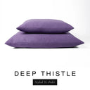 Two luxury dog bed mattresses in a rich deep purple upholstery fabric stacked on top of each other, with 'DEEP THISTLE' and a black 'Styled To Order' label on a white background; these machine washable dog bed mattresses are made for lasting comfort and easy care.