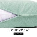 Close-up of a pale sage green machine washable dog bed mattress with its removable cover partially unzipped, revealing the deep-filled luxury dog bed mattress inside, above a white banner with the text 'HONEYDEW' and 'Styled To Order'.