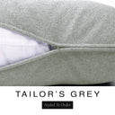 Close-up of a classic mid grey machine washable dog bed mattress with its removable cover partially unzipped, revealing the deep-filled luxury dog bed mattress inside, above a white banner with the text 'TAILOR'S GREY' and 'Styled To Order'.