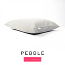 A luxury machine washable dog bed mattress in a light beige-grey upholstery fabric with 'PEBBLE' and a pink 'Core Collection' label on a white background.