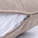 Close up detail of the cover of a luxury dog bed mattress with the zip unzipped to show a white internal mattress.