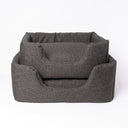 Two dark-brown high-sided luxury dog beds by designers Charley Chau stacked on top of each other on white backdrop.