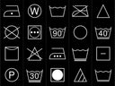 A grid of white laundry care symbols on a black background, including icons for washing, ironing, drying, and care instructions.