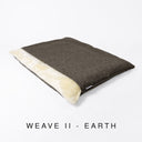 A luxury snuggle sack style dog burrow bag by designers Charley Chau in a dark brown woven upholstery fabric with a cream plush lining on a white background with text "Weave II - Earth".
