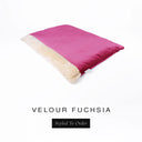 A luxurious Dog Burrow Bag, a sleeping bag style dog bed or snuggle sack style dog bed, with an outer cover in bright fuchsia pink upholstery-quality Velour with a plush, cream faux-fur lining, and a badge with the colour name Fuchsia on a white background.