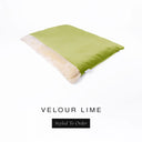 A luxurious Dog Burrow Bag, a sleeping bag style dog bed or snuggle sack style dog bed, with an outer cover in lime green upholstery-quality Velour with a plush, cream faux-fur lining, and a badge with the colour name Lime on a white background.